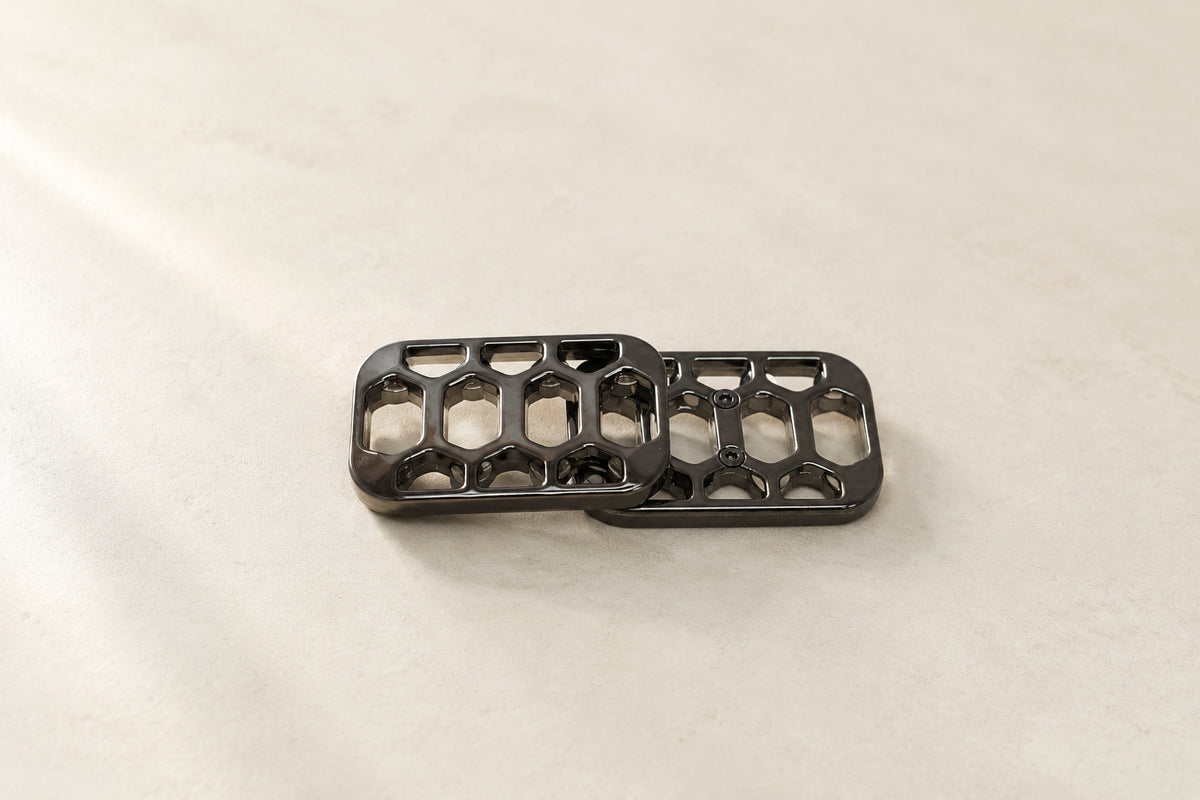 Arca magnetic fidget slider with two offset plates on a pale surface.