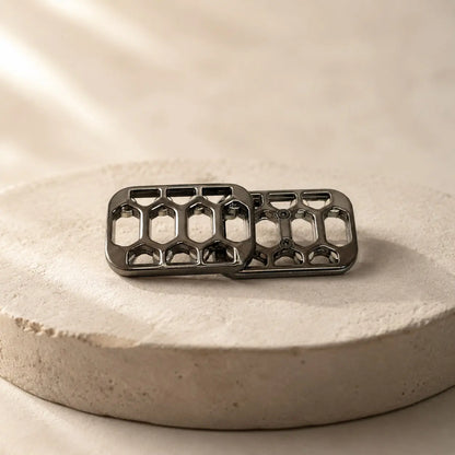 Arca magnetic slider with offset plates resting on a round display stand.