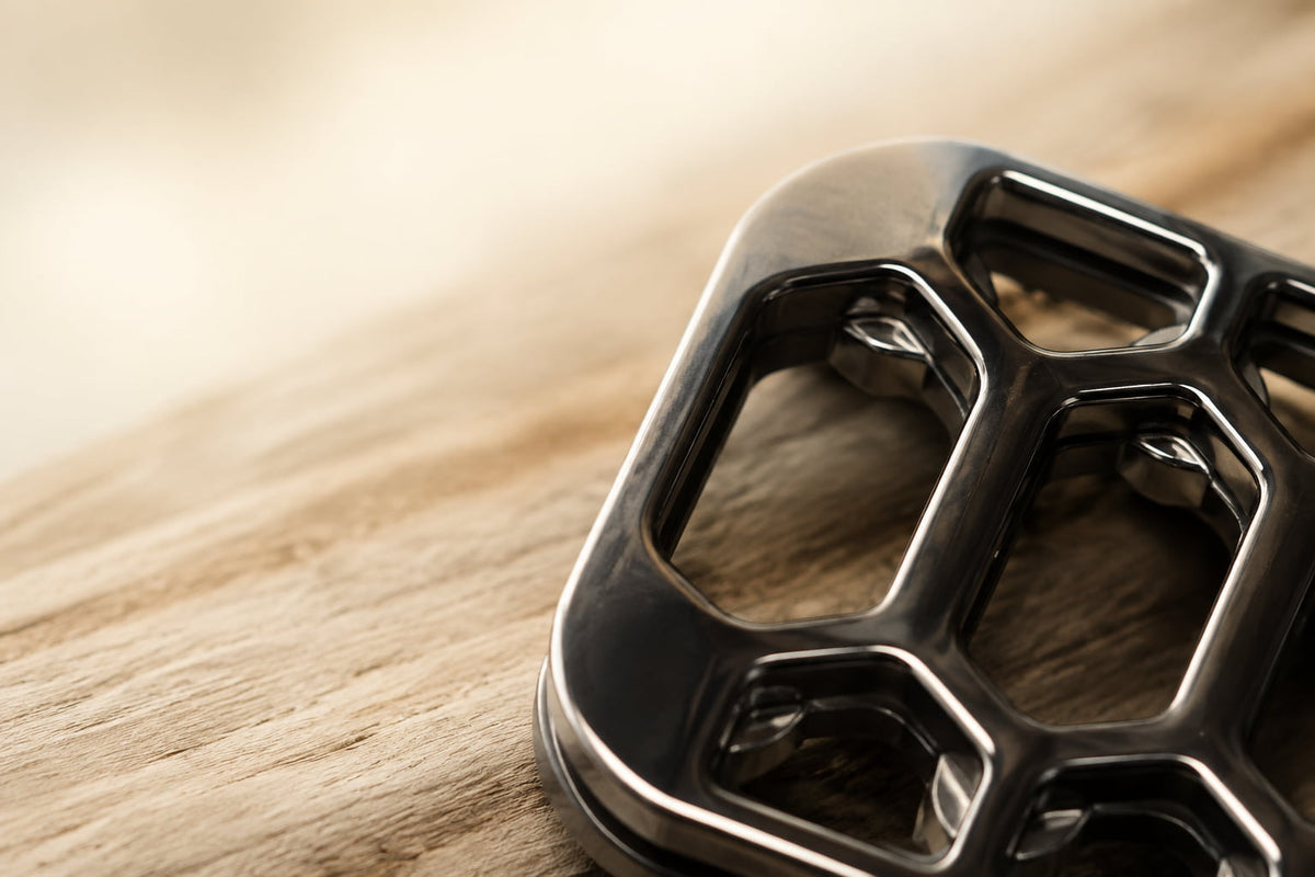 Close-up of the rounded corner and window-like cutouts on the Arca fidget slider.