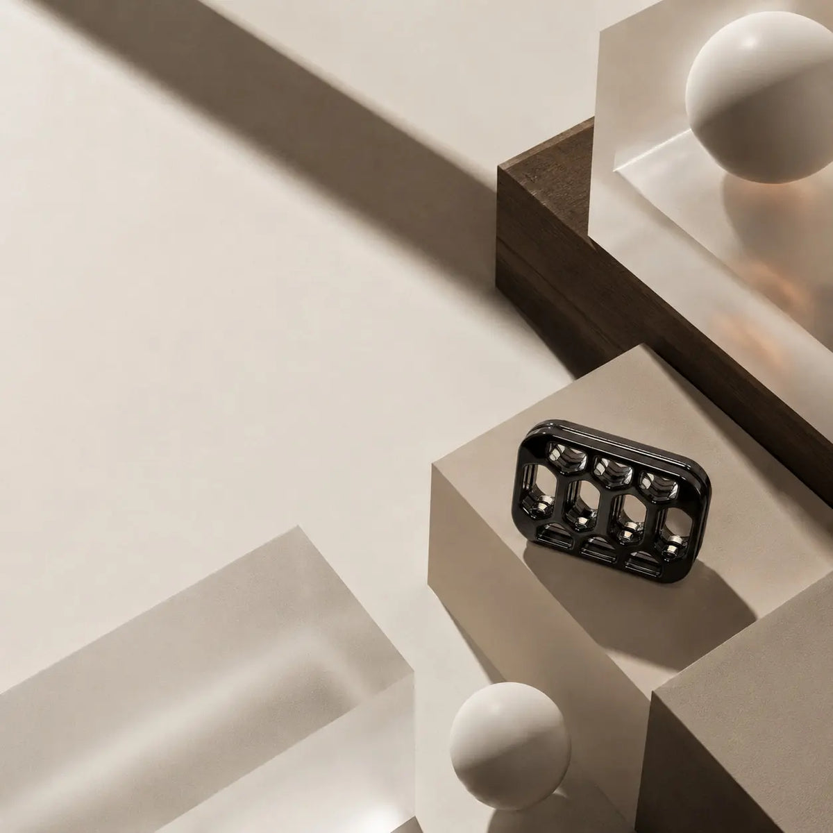 Arca open-frame fidget slider on a square block among geometric display objects.