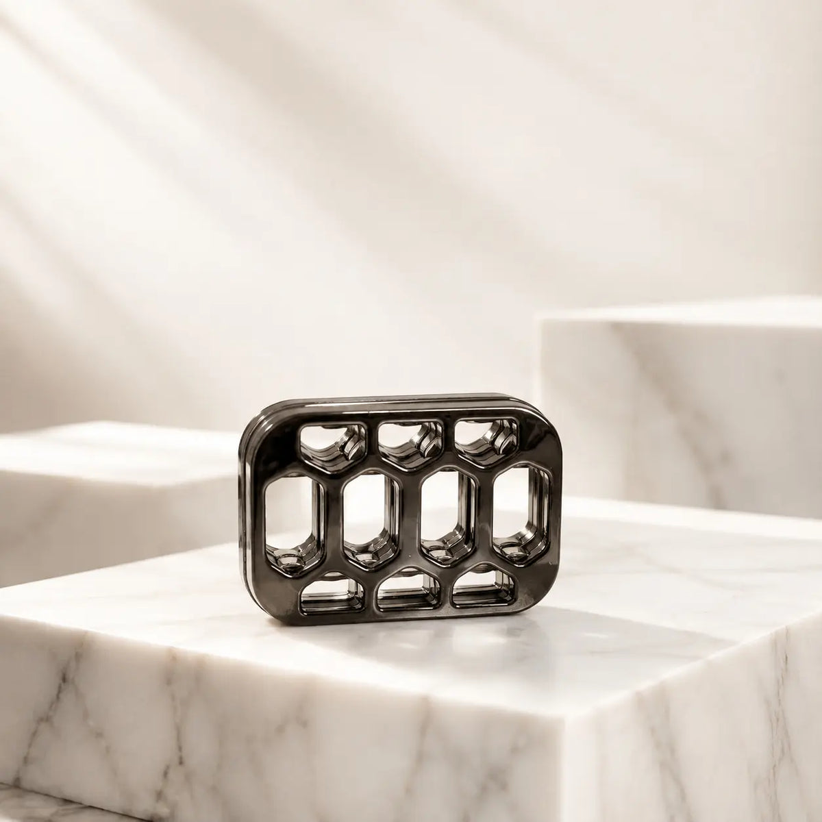 Front view of the Arca open-frame fidget slider standing on a veined display block.