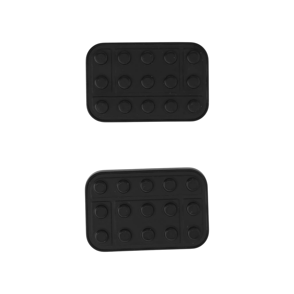 Two separated Brix slider plates showing their dark outer faces with rows of round studs.