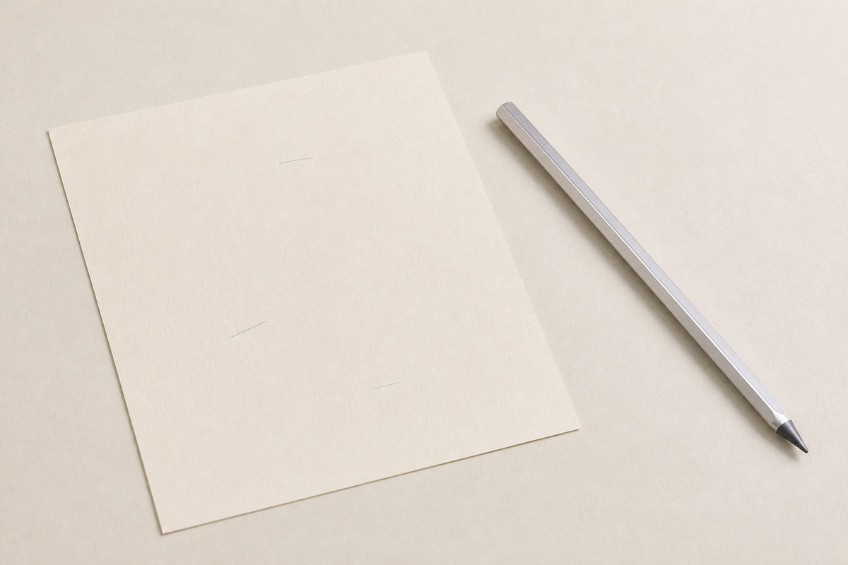 Facet pencil beside a sheet of paper