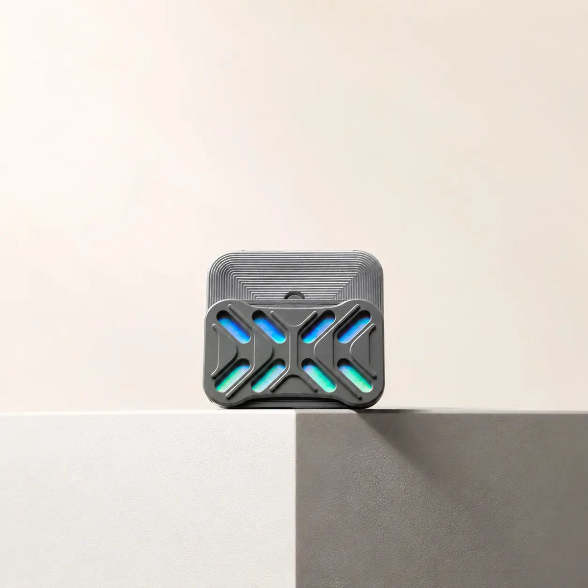 Gleam magnetic slider standing on the edge of a pale ledge with its back plate offset.