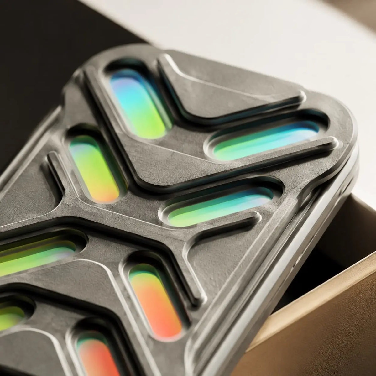 Close-up of Gleam’s cutout face, showing colored inserts and curved edges.