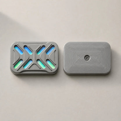 The two Gleam slider plates side by side, showing iridescent cutouts and fine grooves.