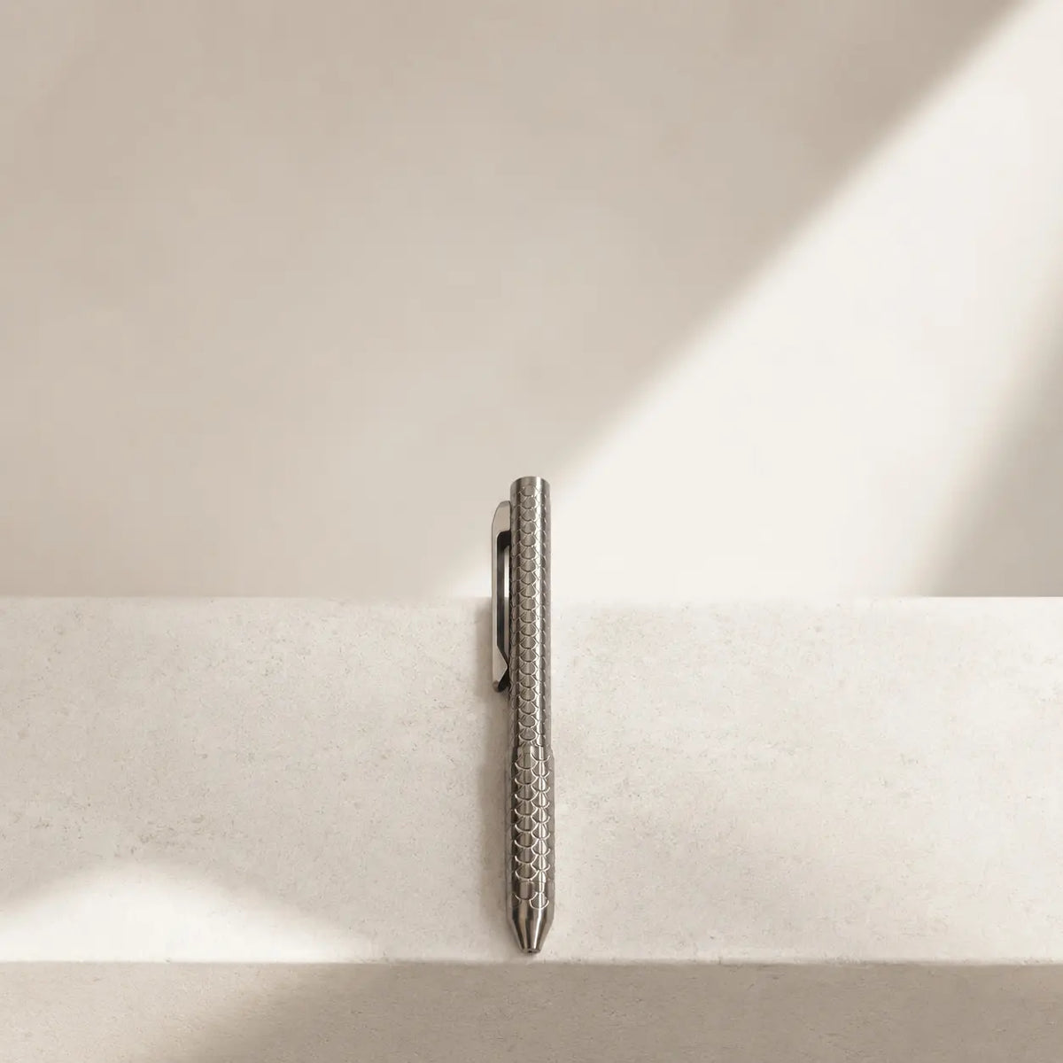 Imbra EDC pen arranged vertically on a pale stone ledge