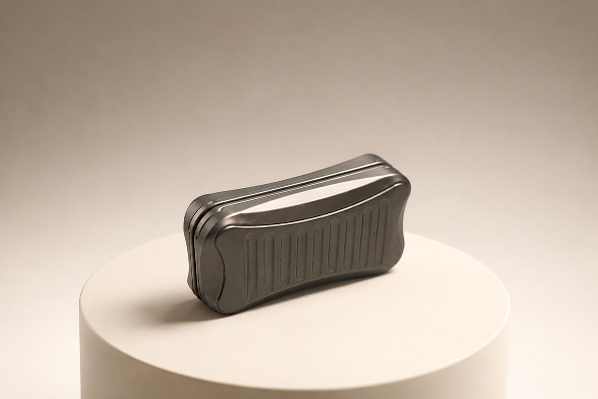 Stria magnetic slider standing on its side with both plates together on a pale round stand.