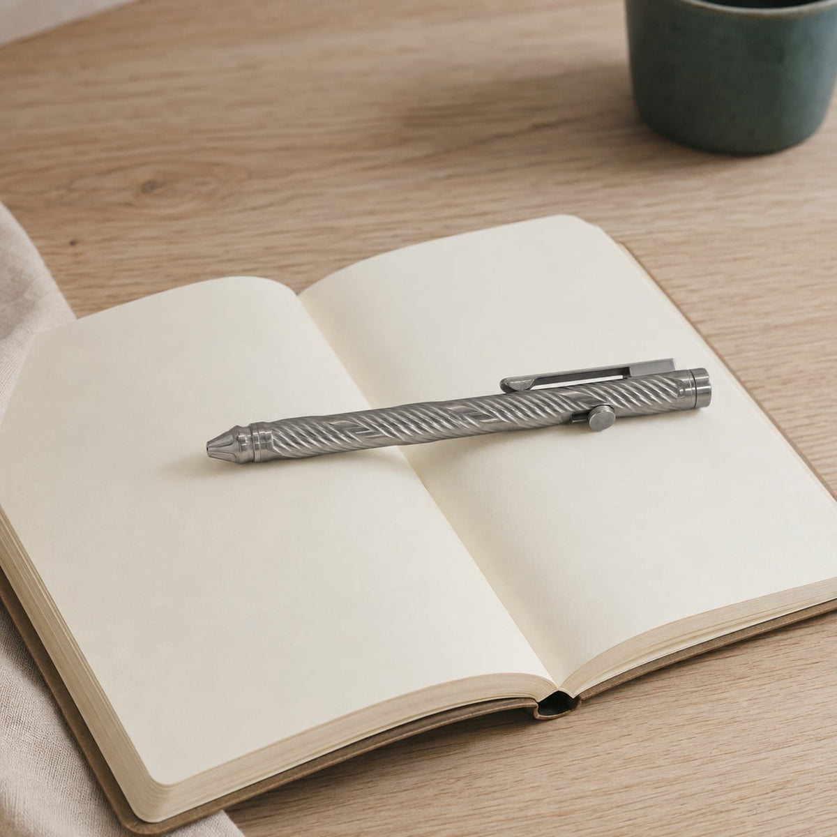 Whorl pen resting across an open blank notebook